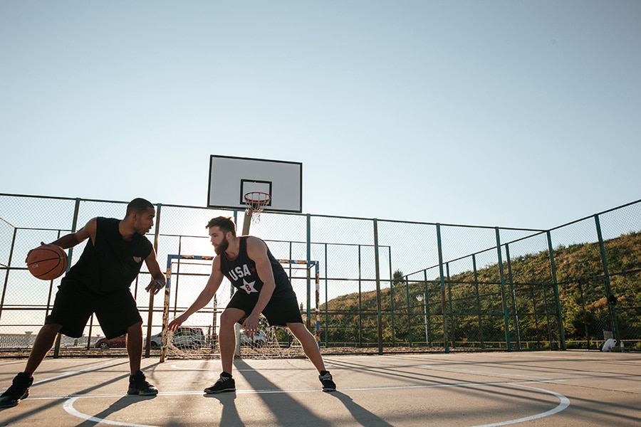 people playing basketball outdoors